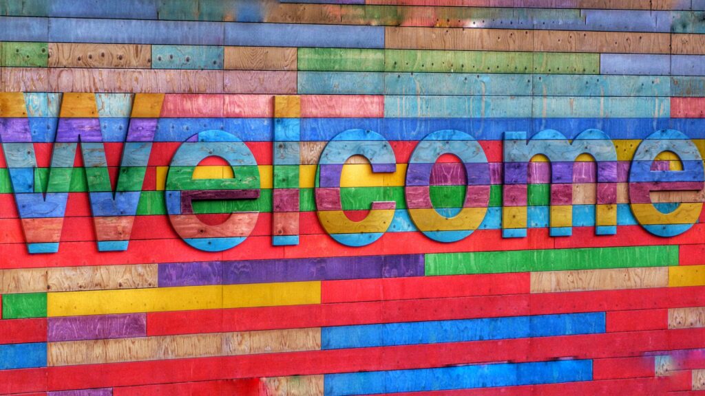 Welcome sign made of colourful blocks of wood.