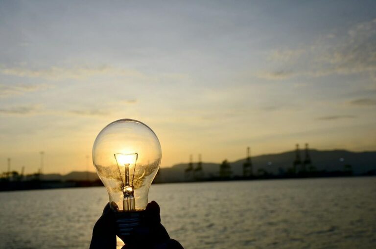 a light bulb in front of a lake