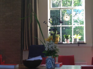 a vase of flowers on a table with folders