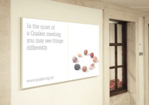 poster saying, 'in the quiet of a Quaker meeting you may see things differently'