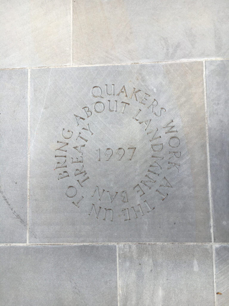 paving slab saying 1997 Quakers work at the UN to bring about landmine ban treaty.